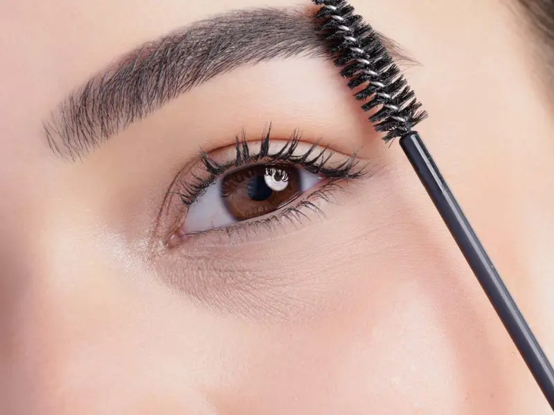 Groomed eyebrow being brushed into shape Beauty by Ana St Albans